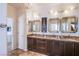 Bathroom boasts a granite countertop and ample mirror space with decorative sconces at 1794 Morro Vista Dr, Las Vegas, NV 89135