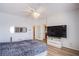 Bright main bedroom features wood floors, ceiling fan, and a large TV at 1794 Morro Vista Dr, Las Vegas, NV 89135