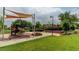Well-maintained playground features slides, swings, and a grassy area for to play and explore at 1794 Morro Vista Dr, Las Vegas, NV 89135