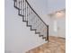 Elegant staircase with decorative iron railing, tile flooring, and a bright, inviting atmosphere at 1794 Morro Vista Dr, Las Vegas, NV 89135