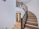 Grand staircase with wrought iron railing, light wood steps, chandelier, and views of the entry at 1794 Morro Vista Dr, Las Vegas, NV 89135