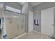 Bathroom with glass shower doors, and white tiling at 1809 Solana Del Norte Way, North Las Vegas, NV 89031