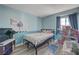 Bright bedroom with light blue walls, black metal bed frame, and a cozy, playful decor at 1809 Solana Del Norte Way, North Las Vegas, NV 89031