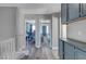 Hallway features blue cabinets, stairway, and two bedrooms in view at 1809 Solana Del Norte Way, North Las Vegas, NV 89031