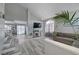 Open-concept living space with vaulted ceilings, fireplace, hardwood floors, and cozy seating area at 1809 Solana Del Norte Way, North Las Vegas, NV 89031