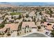 A home surrounded by desert landscaping and mature trees in a quiet neighborhood at 2177 Magnolia Pond Ct, Henderson, NV 89052