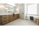 Bathroom with a soaking tub, walk-in shower, and dual vanity with wood cabinets and modern fixtures at 2177 Magnolia Pond Ct, Henderson, NV 89052