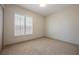 This bedroom offers plush carpeting, neutral walls, and a bright window at 2177 Magnolia Pond Ct, Henderson, NV 89052