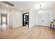 Inviting entryway with wood floors, modern lighting, and view into an office at 2177 Magnolia Pond Ct, Henderson, NV 89052