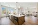 Modern kitchen with large island, stainless steel appliances, and an adjoining living area at 2177 Magnolia Pond Ct, Henderson, NV 89052