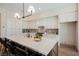 Modern kitchen with a large island, white cabinets, and stainless-steel appliances at 2177 Magnolia Pond Ct, Henderson, NV 89052