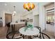 Gourmet kitchen features island seating, stainless appliances, and adjacent dining area at 2177 Magnolia Pond Ct, Henderson, NV 89052