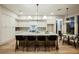 Spacious kitchen featuring a large island with bar seating, modern appliances, and bright lighting fixtures at 2177 Magnolia Pond Ct, Henderson, NV 89052