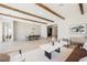 Spacious living and dining area with wood beams, stylish decor, and plenty of natural light at 2177 Magnolia Pond Ct, Henderson, NV 89052