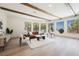 Bright living room with wood beams, large windows, and contemporary furniture at 2177 Magnolia Pond Ct, Henderson, NV 89052