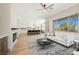 Open-concept living area with fireplace, modern furnishings, and views into the kitchen and dining space at 2177 Magnolia Pond Ct, Henderson, NV 89052