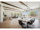 Open living and dining area featuring exposed wood beams, chandelier, and large windows with outdoor views at 2177 Magnolia Pond Ct, Henderson, NV 89052