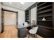 Comfortable home office featuring built-in bookshelves, a desk, and natural lighting at 2177 Magnolia Pond Ct, Henderson, NV 89052