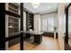 Stylish home office with custom built-ins, modern desk, and bright window at 2177 Magnolia Pond Ct, Henderson, NV 89052