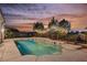 Backyard pool with string lights and city views at dusk at 2177 Magnolia Pond Ct, Henderson, NV 89052