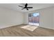 Bedroom boasts modern flooring, ceiling fan, and sliding glass doors to a private patio at 2211 Frontier Ave, Las Vegas, NV 89106