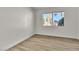 Neutral bedroom showcases modern flooring and a large window with views of the outdoors at 2211 Frontier Ave, Las Vegas, NV 89106