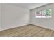 Cozy bedroom with modern flooring and a window overlooking the trees at 2211 Frontier Ave, Las Vegas, NV 89106
