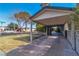 View of the driveway and carport of home featuring mature landscaping and a classic desert facade at 2211 Frontier Ave, Las Vegas, NV 89106
