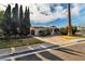 Charming single-story home with a well-manicured lawn, mature trees, and a driveway at 2211 Frontier Ave, Las Vegas, NV 89106