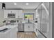 Well-lit kitchen with white cabinets, stainless steel appliances, and quartz countertops throughout at 2211 Frontier Ave, Las Vegas, NV 89106
