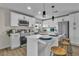 Modern kitchen features white cabinets, stainless steel appliances, and a quartz countertop island with seating at 2211 Frontier Ave, Las Vegas, NV 89106