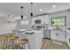 Lovely kitchen boasts white cabinets, stainless appliances, and a central island with seating area at 2211 Frontier Ave, Las Vegas, NV 89106