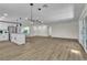 Open living area with modern kitchen and flooring, and view of the entry door at 2211 Frontier Ave, Las Vegas, NV 89106