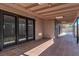 Covered patio with tile flooring, sliding glass doors, and access to the backyard with a pool at 2211 Frontier Ave, Las Vegas, NV 89106