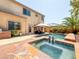 Beautiful backyard pool and spa area with an outdoor kitchen and plenty of space to entertain at 2382 Sunburst View St, Henderson, NV 89052