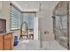 Bright bathroom showcasing a glass-enclosed shower, sleek window blinds, and vanity area with storage at 2382 Sunburst View St, Henderson, NV 89052