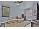 Bright bedroom featuring a sofa, a dresser, window blinds, and a ceiling fan for comfortable living at 2382 Sunburst View St, Henderson, NV 89052