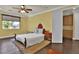 Comfortable bedroom with ceiling fan, window overlooking the backyard, and well-organized closet space at 2382 Sunburst View St, Henderson, NV 89052