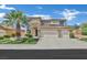 Charming two-story home with a well-manicured lawn and desert landscaping including a mature palm tree at 2382 Sunburst View St, Henderson, NV 89052