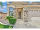 Stunning front entrance of a home with a desert landscape and stone accents at 2382 Sunburst View St, Henderson, NV 89052