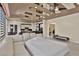 Bright, spacious living room with white sofa and modern ceiling design with partial view of kitchen and dining area at 2382 Sunburst View St, Henderson, NV 89052