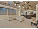 Open living area with modern lighting, comfortable seating, and an adjacent kitchen at 2382 Sunburst View St, Henderson, NV 89052
