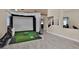 Modern living room features a golf simulator, large windows, and high ceilings at 2382 Sunburst View St, Henderson, NV 89052
