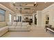 Open-concept living room with tile flooring, modern lighting, and access to the kitchen at 2382 Sunburst View St, Henderson, NV 89052