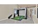 Spacious room featuring a golf simulator and neutral wall colors at 2382 Sunburst View St, Henderson, NV 89052
