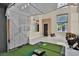 A modern living space features a golf simulator and high ceilings with large windows at 2382 Sunburst View St, Henderson, NV 89052