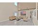 Bright living room with high ceilings, neutral decor, and tile flooring at 2382 Sunburst View St, Henderson, NV 89052