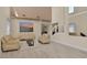 Cozy living room featuring neutral tones, modern furniture, and large windows at 2382 Sunburst View St, Henderson, NV 89052