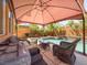 Outdoor patio area featuring comfortable seating, a shade structure, and views of the pool at 2382 Sunburst View St, Henderson, NV 89052