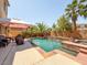 Private backyard swimming pool featuring a built-in spa, covered patio, and mature landscaping at 2382 Sunburst View St, Henderson, NV 89052